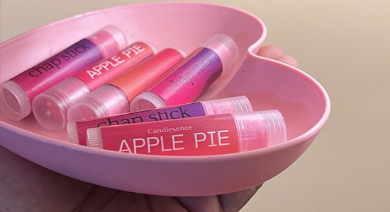 Handmade Apple Pie scented lip balms by Candlesence Online, displayed in a pink, heart-shaped dish.